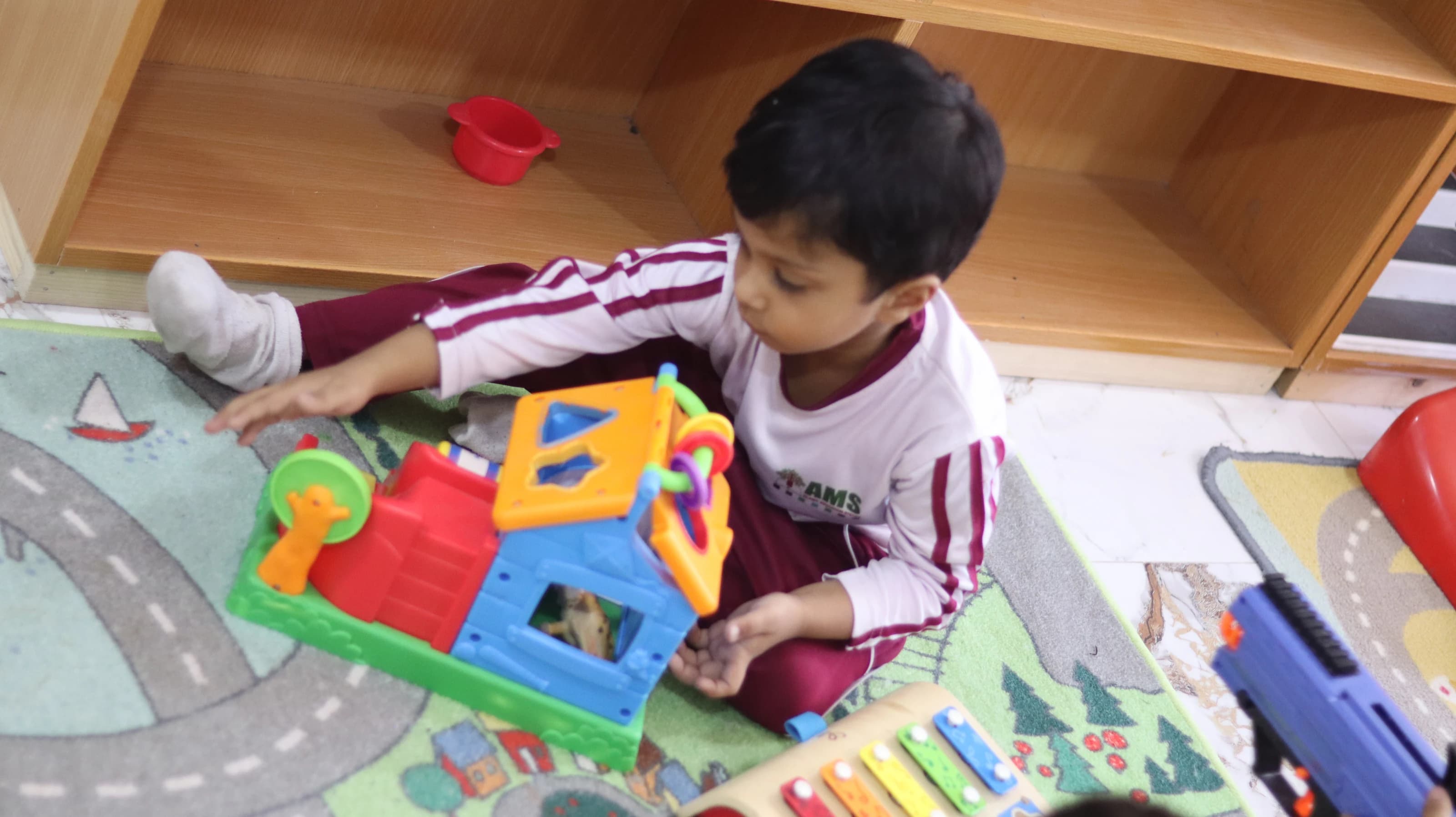 A child arranging colorful learning blocks