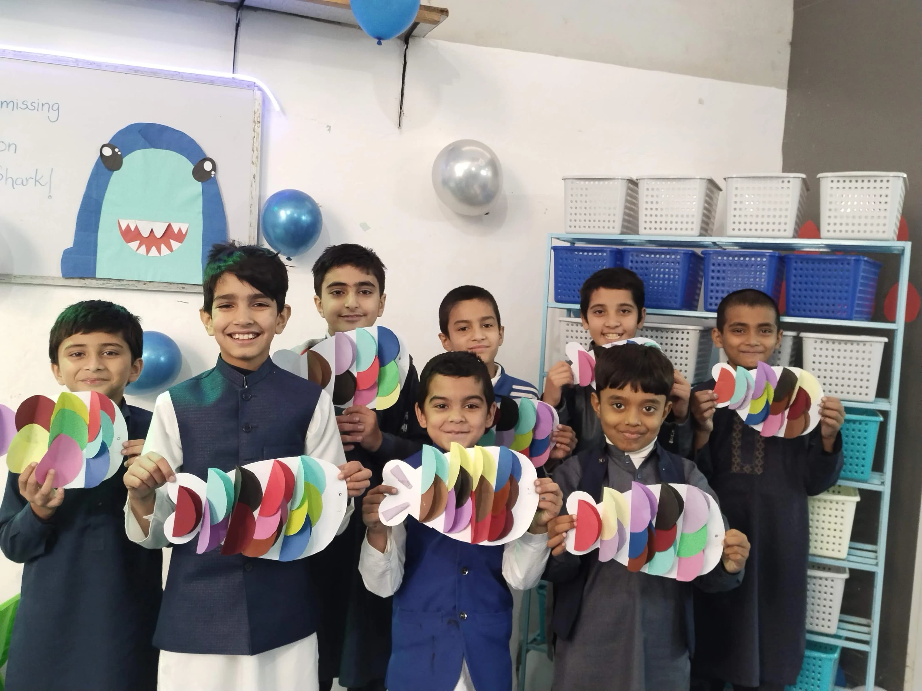 Children showing colorful paper crafts
