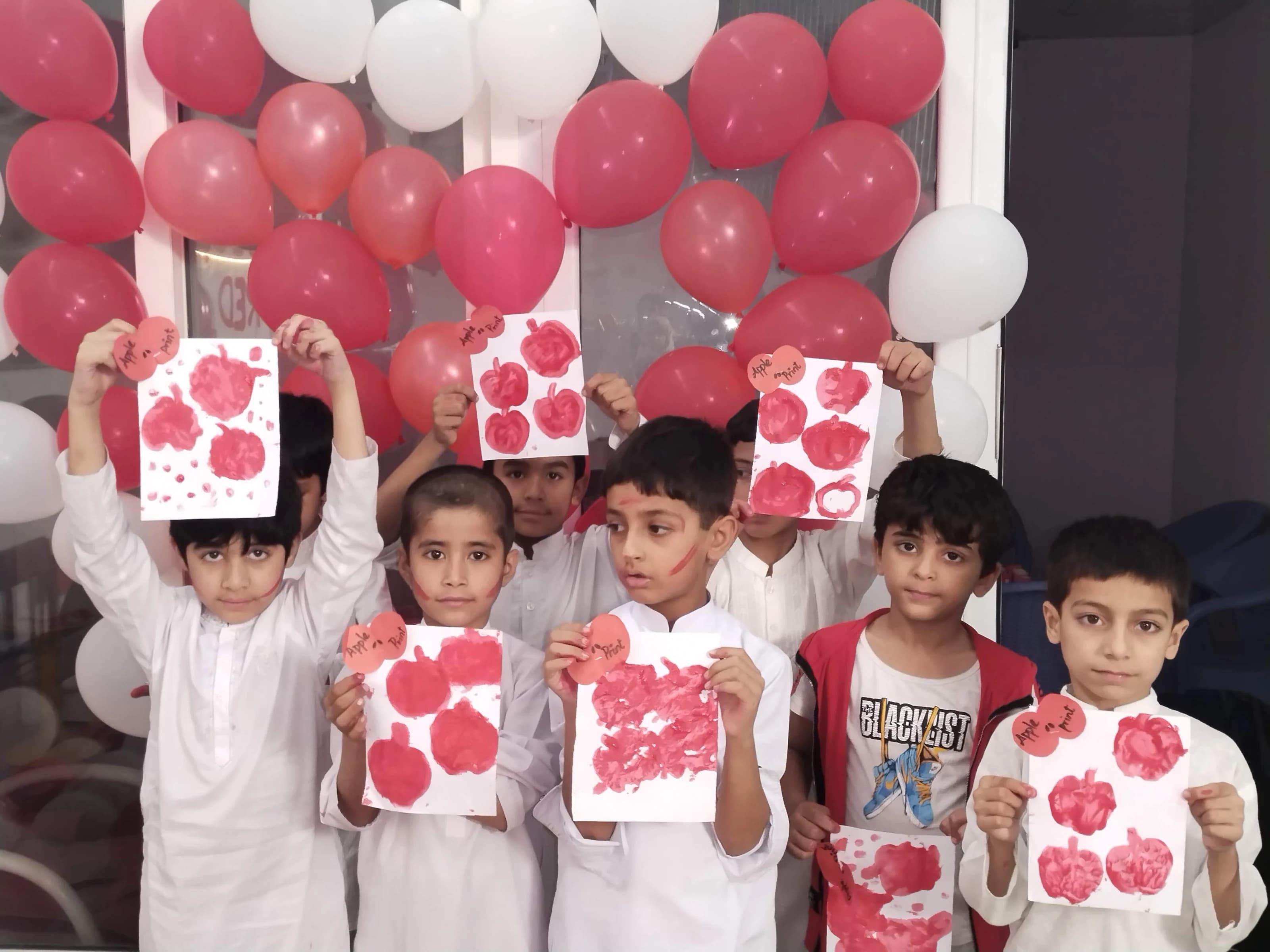 Children presenting Red Day artwork
