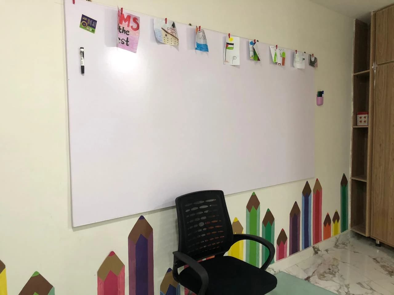 A classroom whiteboard and learning corner
