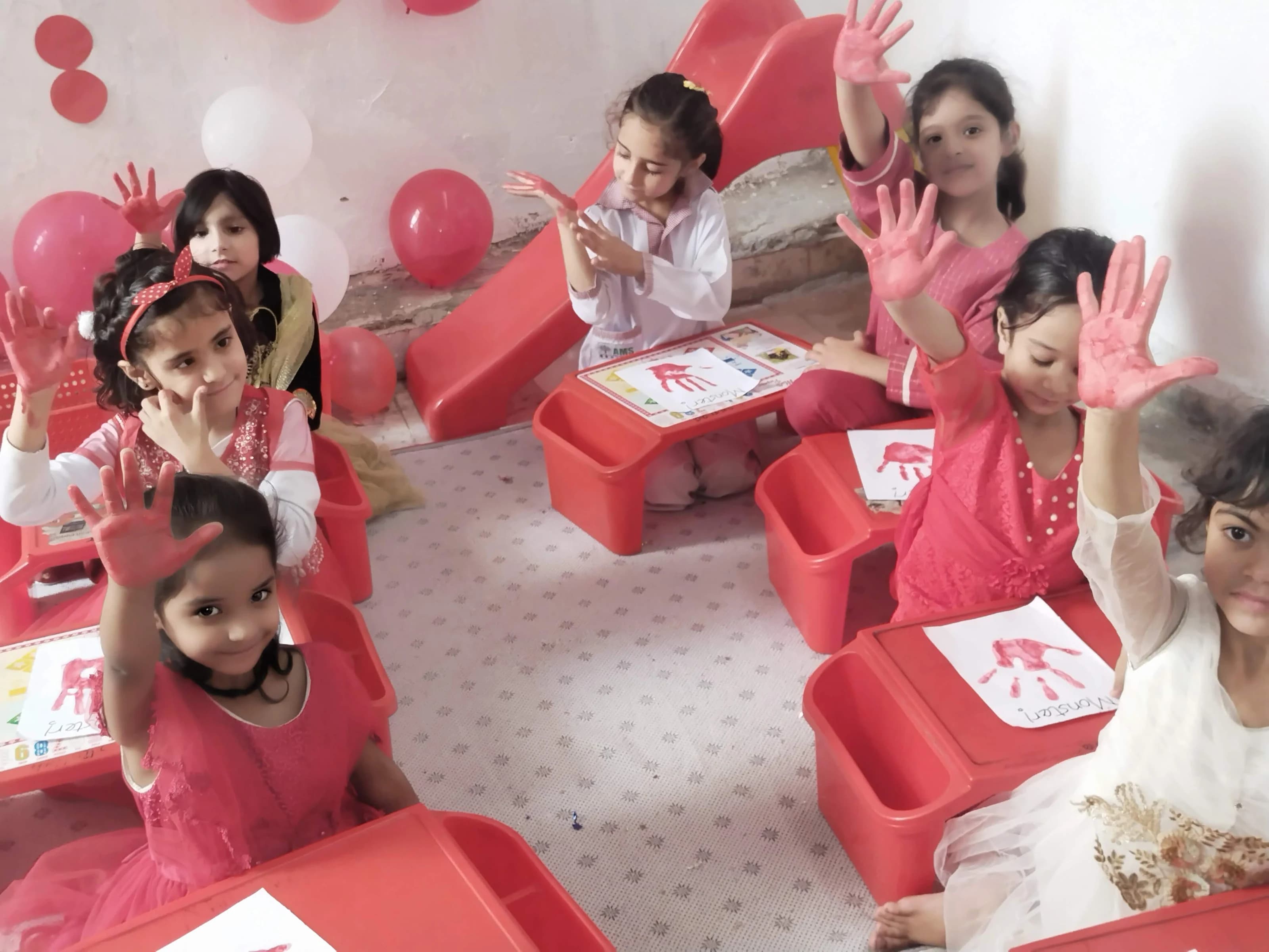 Young children taking part in a Red Day activity