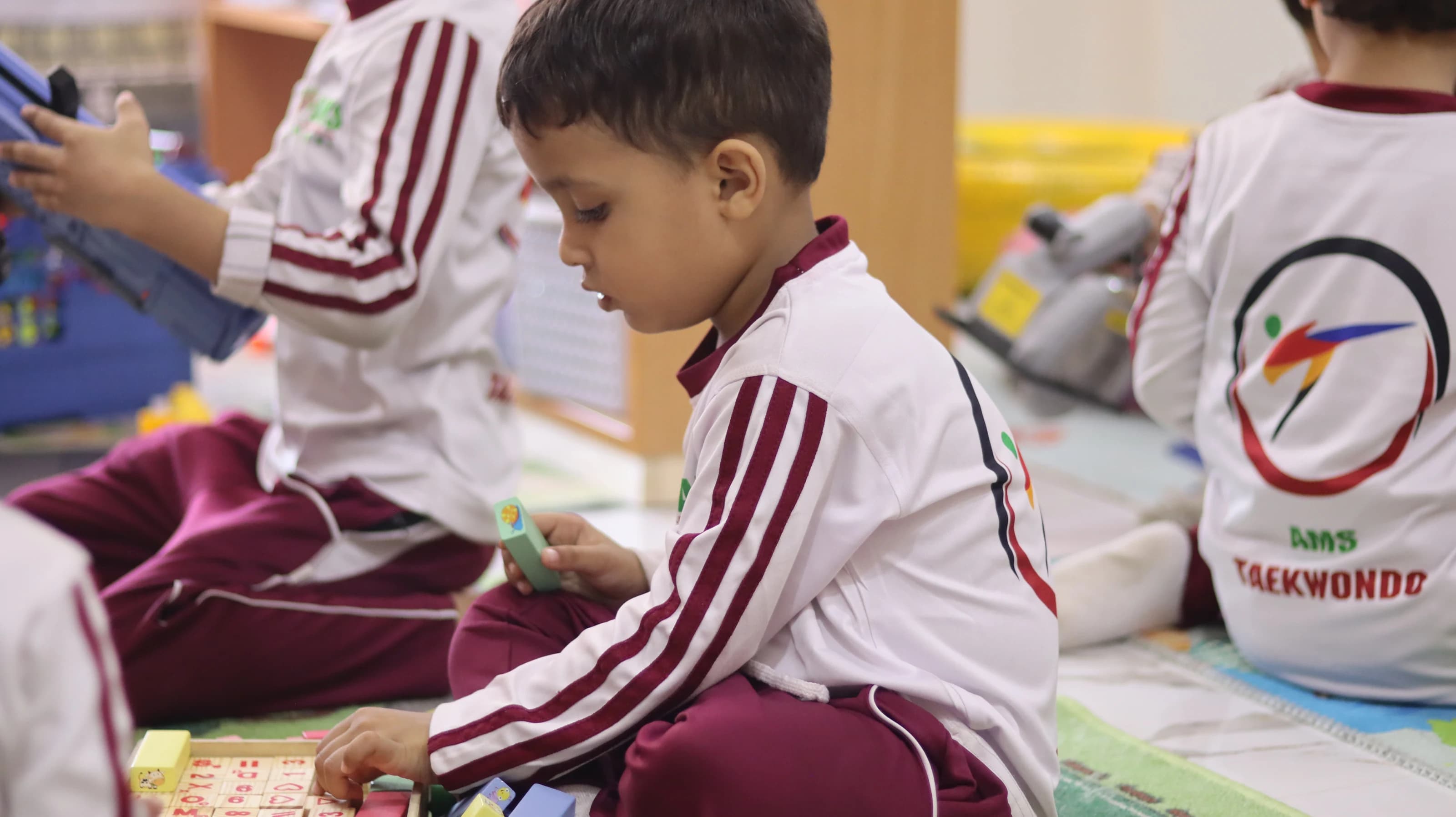 A young student building with colorful blocks