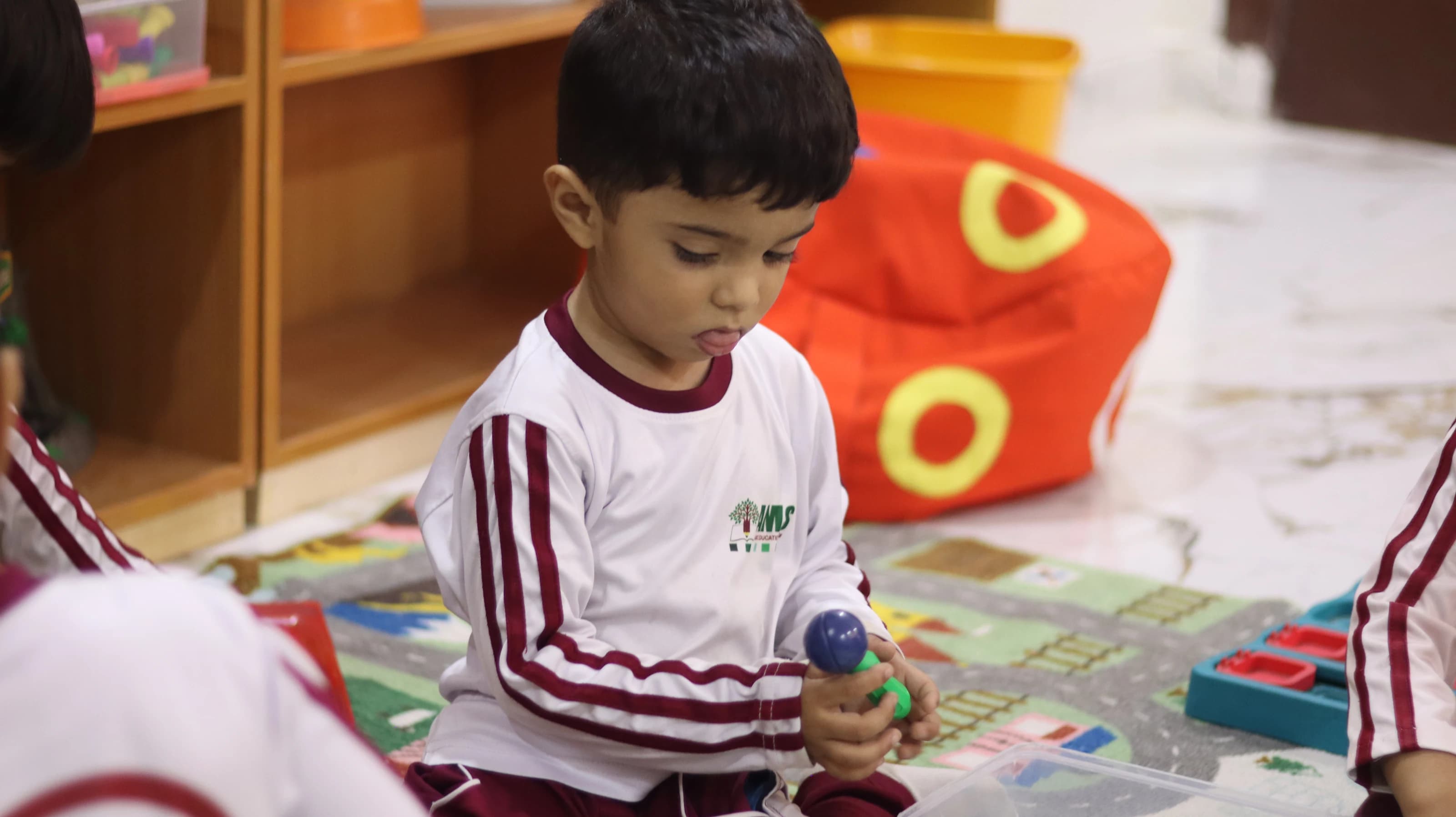 A young child exploring colorful building blocks