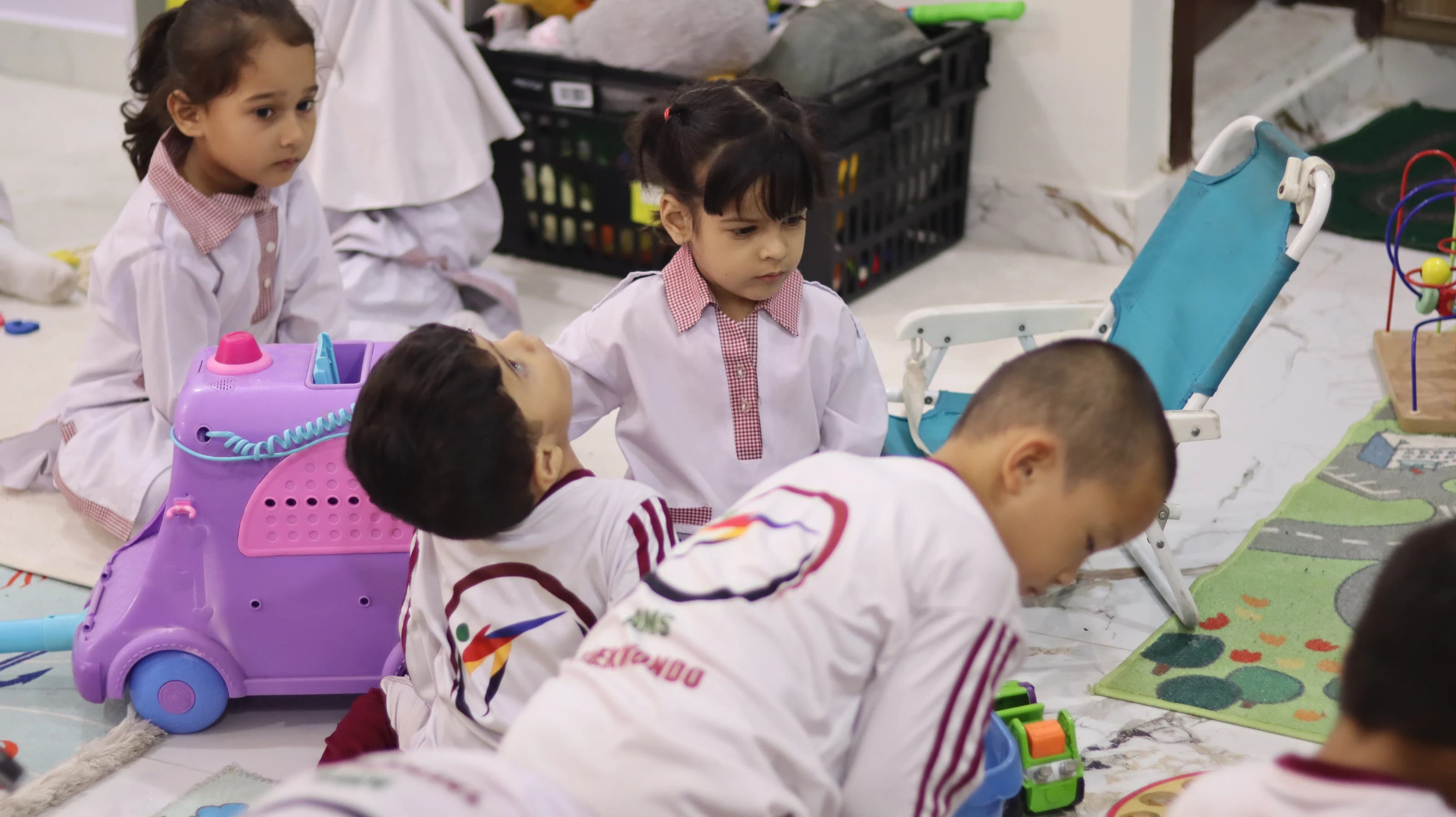 Children exploring toys and learning resources in class