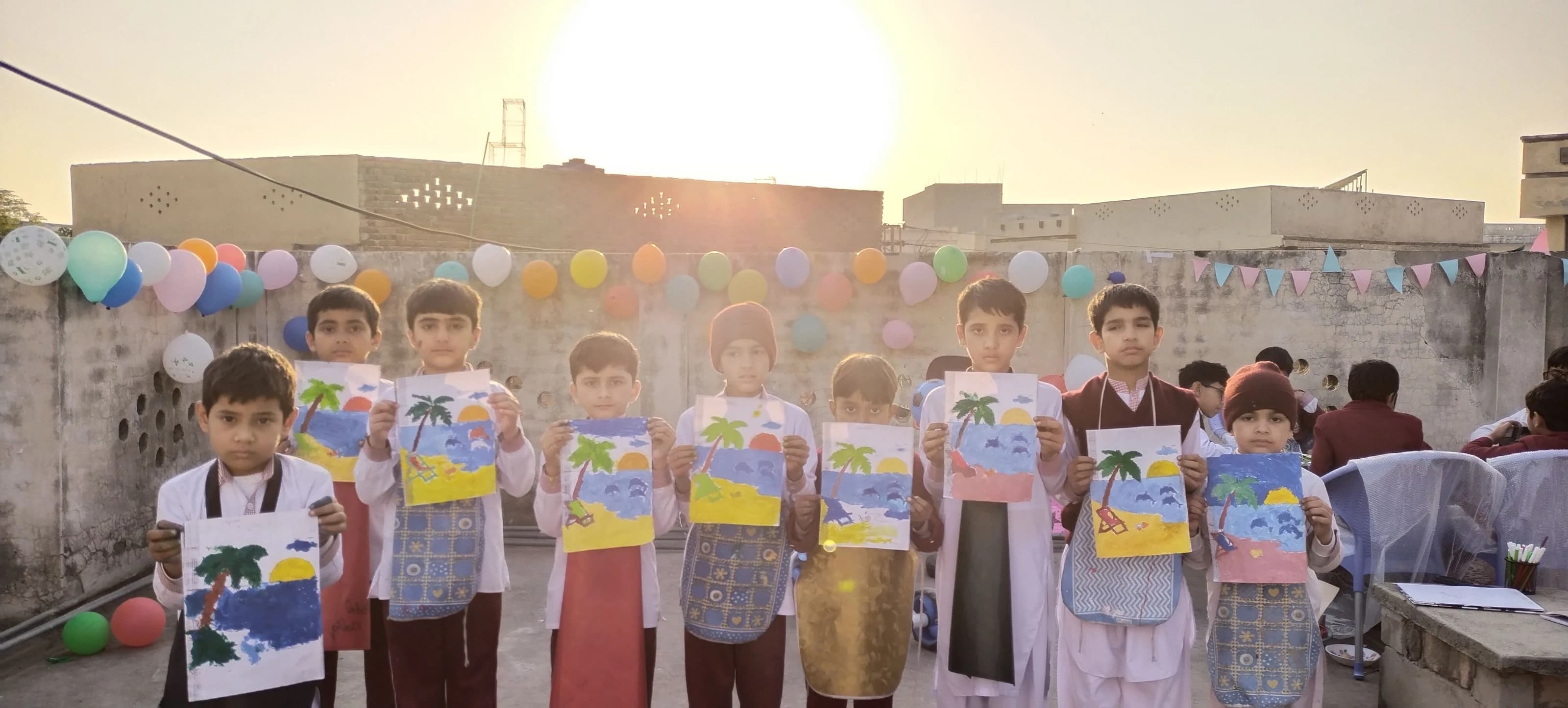 Students proudly displaying their artwork outdoors