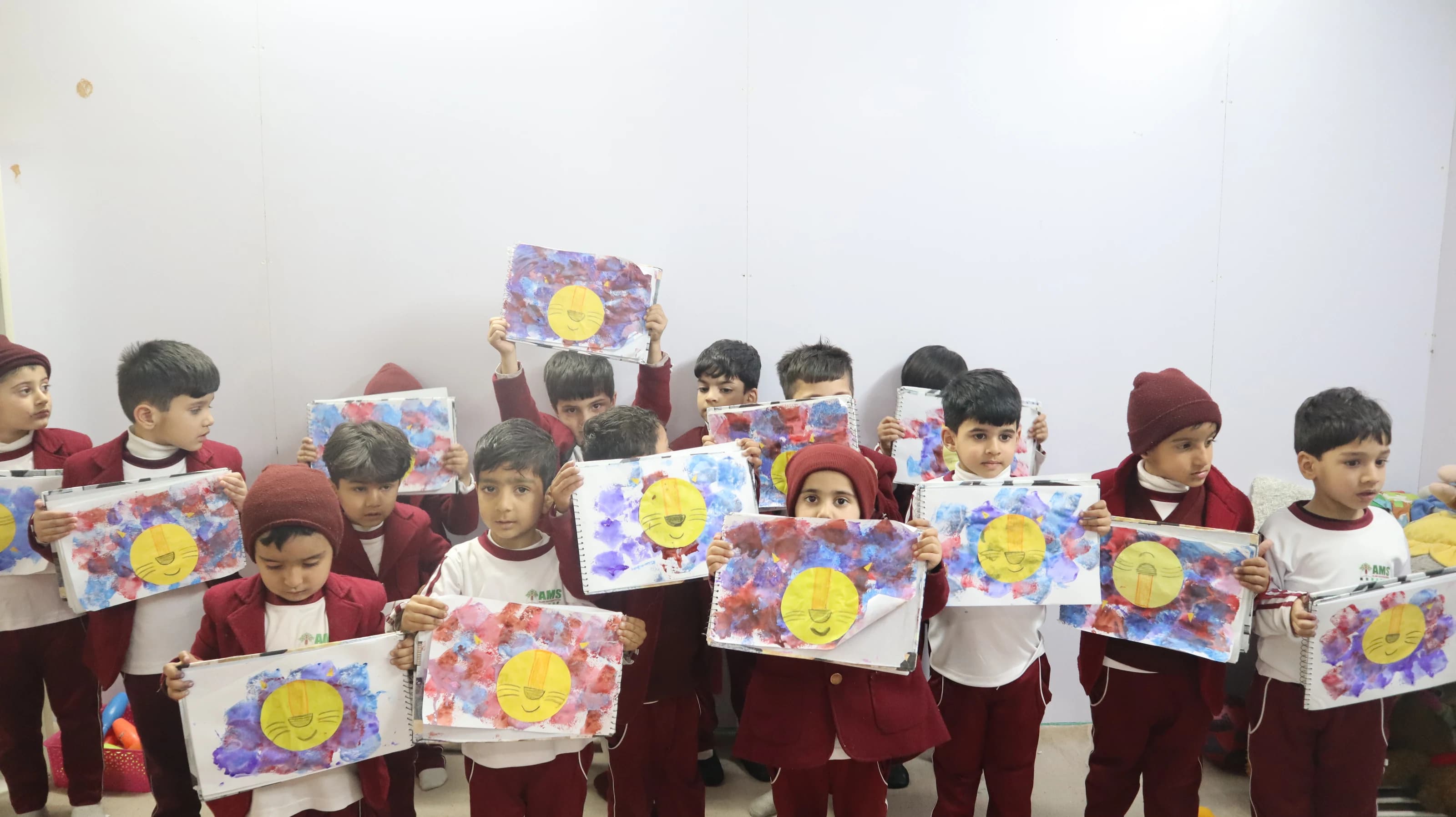 Young students proudly showing their artwork